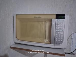 a microwave oven sitting on top of a shelf at Vanildo Oliveira in Uberlândia +14 photos