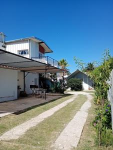 a house with a patio with a table and a balcony at Refugio Amaicha in Embalse