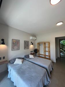 a bedroom with two beds and a window at Pousada Villa Julião in Ilhabela +9 photos