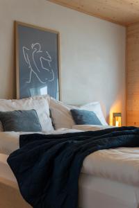 a bed with a black blanket on top of it at Ganzes Haus am Bodensee in den Bergen im Appenzell in Heiden +79 photos