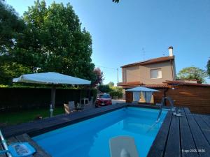 a swimming pool in front of a house at Turistica Via Po 7 in Legnago