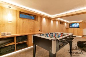 a pool table in a room with wooden walls at Selbstversorgerhaus Herisch in Schladming