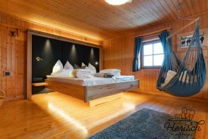 a bedroom with a bed with a hammock in it at Selbstversorgerhaus Herisch in Schladming