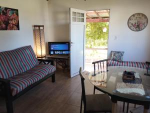 a living room with a couch and a table at Casa Valle Verde in Sierra de los Padres
