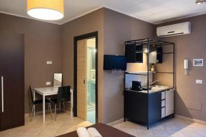 a room with a kitchen and a table with a tablektop at MyBed B&B in Cavallino di Lecce