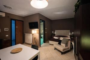 a bedroom with a bed and a living room at MyBed B&B in Cavallino di Lecce