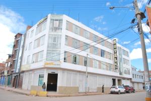 a white building on the corner of a street at Kymeron Hotel in Juliaca