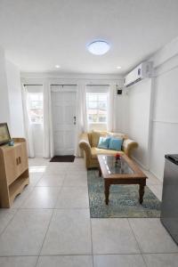 a living room with a couch and a coffee table at Green Serene Apartments in Corinthe