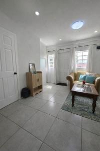 a living room with a couch and a table at Green Serene Apartments in Corinthe