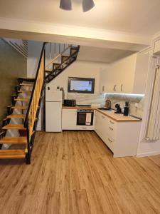 a kitchen with a staircase leading up to a loft at Casa Pop in Oradea