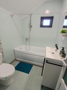 a white bathroom with a toilet and a sink at Casa Pop in Oradea +14 photos