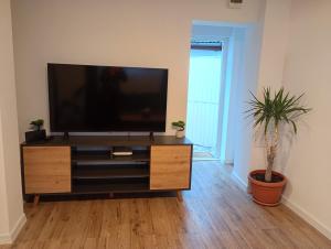 a living room with a flat screen tv on a dresser at Casa Pop in Oradea