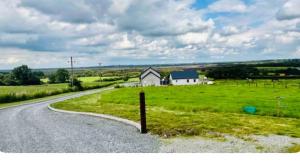 a road leading to a house in a field at 2 Bedroom Workers Apartment in Barrysbrook