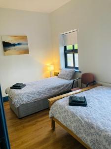 a hotel room with two beds and a window at 2 Bedroom Workers Apartment in Barrysbrook