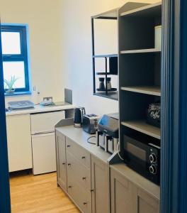 an office with a desk and a computer in a room at 2 Bedroom Workers Apartment in Barrysbrook