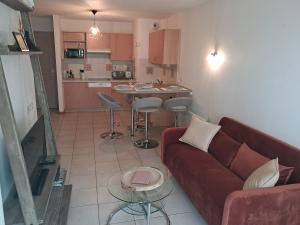 a living room with a couch and a kitchen at welcome toEspace Zen in Levernois
