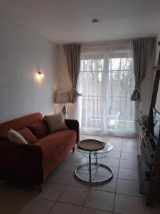 a living room with a couch and a table at welcome toEspace Zen in Levernois