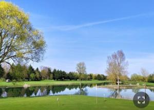 a view of a golf course with a pond at welcome toEspace Zen in Levernois