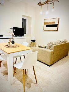 a living room with a table and a couch at Apparemment Cosy - Centre Auch in Auch