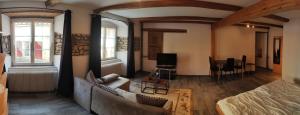 a living room with a couch and a table at maison102 studio Saint-Ursanne Jura in Saint-Ursanne
