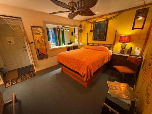 a bedroom with a bed and a desk and a window at Itty Bitty Inn in North Bend
