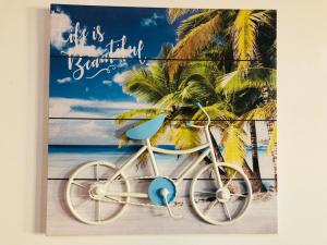a picture of a bike parked on the beach at La buena vida ocean Tamarindo in Tamarindo