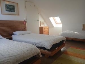 a bedroom with two twin beds and a window at Harbour Views, Coverack in Helston
