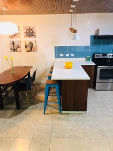 a kitchen with a blue and white counter and a table at La buena vida ocean Tamarindo in Tamarindo