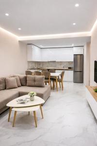 a living room with a couch and a table at Adan Luxury Aparthotel in Orikum