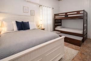 a bedroom with a bed and a bunk bed at Casa Isabel in Rincon +24 photos