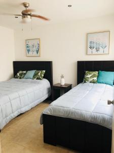 two beds sitting next to each other in a bedroom at La buena vida ocean Tamarindo in Tamarindo