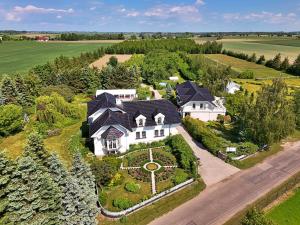 an aerial view of a large white house at Zielone Zacisze in Murzynowo Kościelne