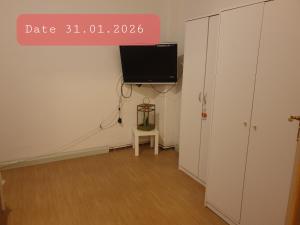 a room with a flat screen tv on the wall at Monteurwohnung bei Nina 1OGL in Zeitz