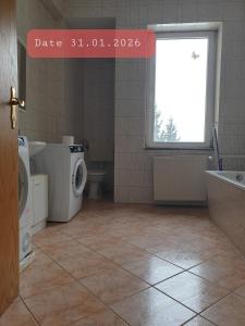 a bathroom with a toilet and a sink and a window at Monteurwohnung bei Nina 1OGL in Zeitz