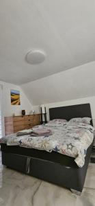 a bedroom with a bed with a comforter on it at Zekića konaci in Ljubiš