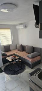 a living room with a couch and a table at Zekića konaci in Ljubiš