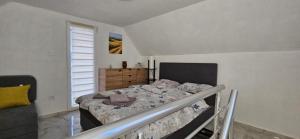 a bedroom with a bed and a dresser in it at Zekića konaci in Ljubiš