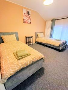 a bedroom with two beds and a table in it at Casa Pop in Oradea