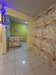 a bathroom with a stone wall in a room at Hotel Padre Vitor in Aparecida