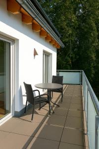 a patio with two chairs and a table on a balcony at Villa Viktoria 3 - Apartments in Ingolstadt