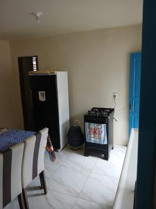 a kitchen with a stove and a refrigerator at Casas oliveira in Paraty