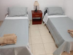 two beds sitting next to each other in a room at Los Pinos de Horizonte in Fernández +4 photos