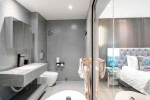 a bathroom with a sink toilet and a bed at Waterhead Bath Suites - Parking and Light Breakfast in Ambleside +58 photos