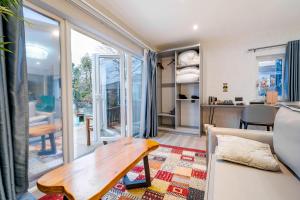 a living room with a couch and a table at Waterhead Bath Suites - Parking and Light Breakfast in Ambleside