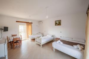 a living room with two beds and a table at Garden Villa Dhesara in Ksamil