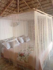 a bedroom with a bed with a mosquito net at EL Cielo de Cana in Las Terrenas