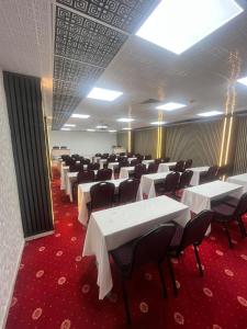 a room with white tables and chairs in it at Blue Lake Otel in Beysehir