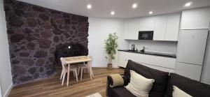 a living room with a couch and a table at La Cueva de Villa Gardel in Icod de los Vinos
