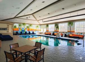 a hotel room with a pool and a table and chairs at Comfort Inn Sandusky in Sandusky