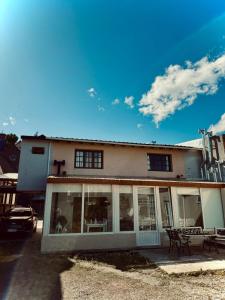 a house with glass windows and a patio at Isla Bella in Ushuaia